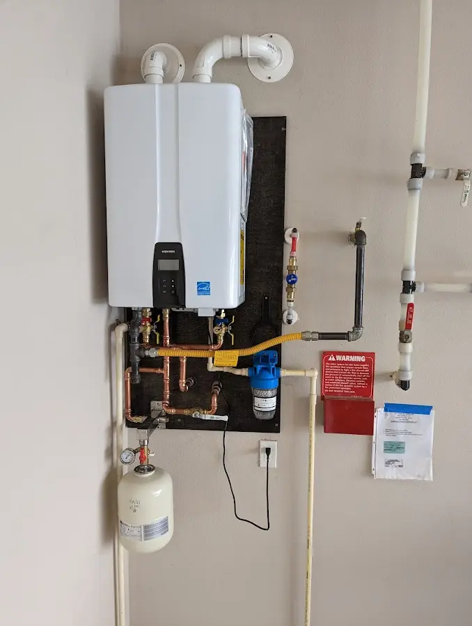 Professional plumber installing copper piping in a Valley Center home